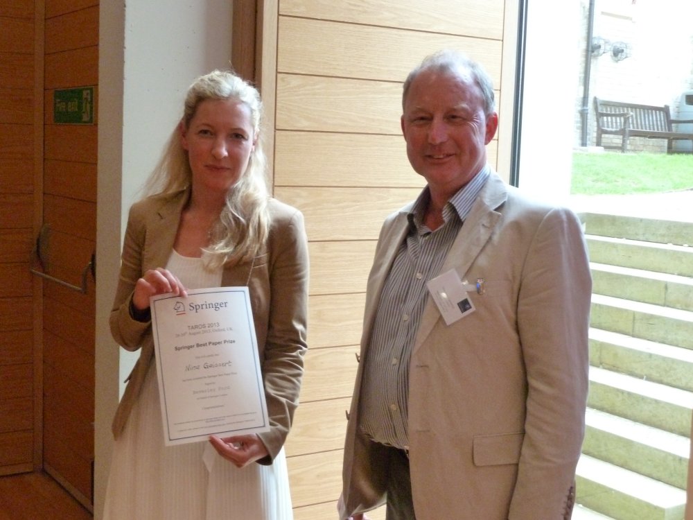 Nina Gaissert receiving the Springer Best Paper Award from Stephen Cameron