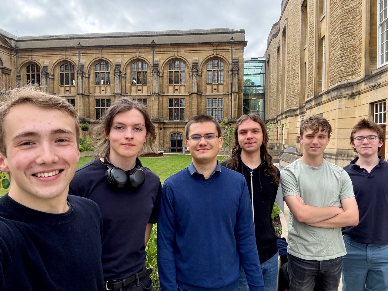 Team 16 are smiling for the camera, standing outside the Museum. There are six students.