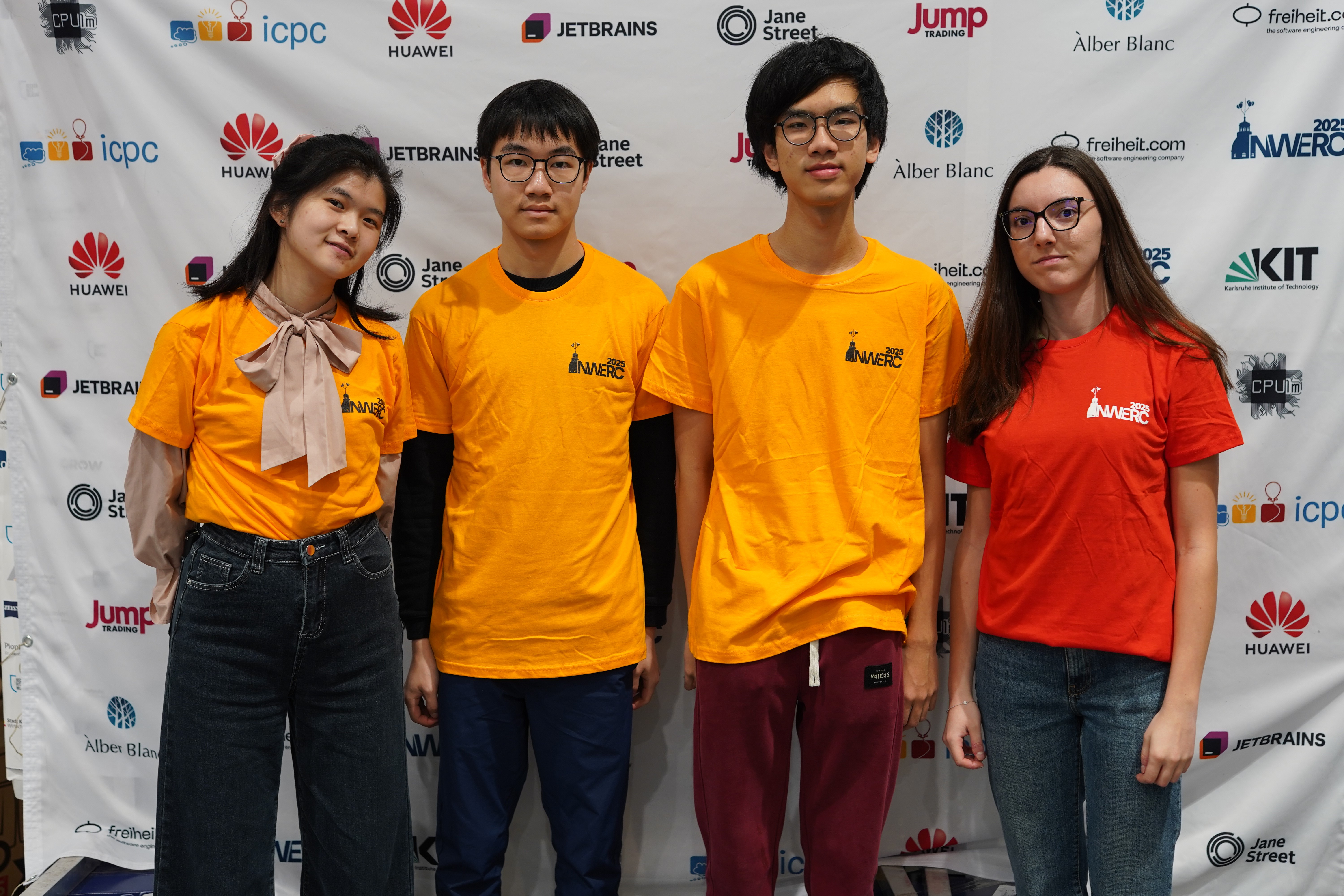 The four winning students smiling, posed together