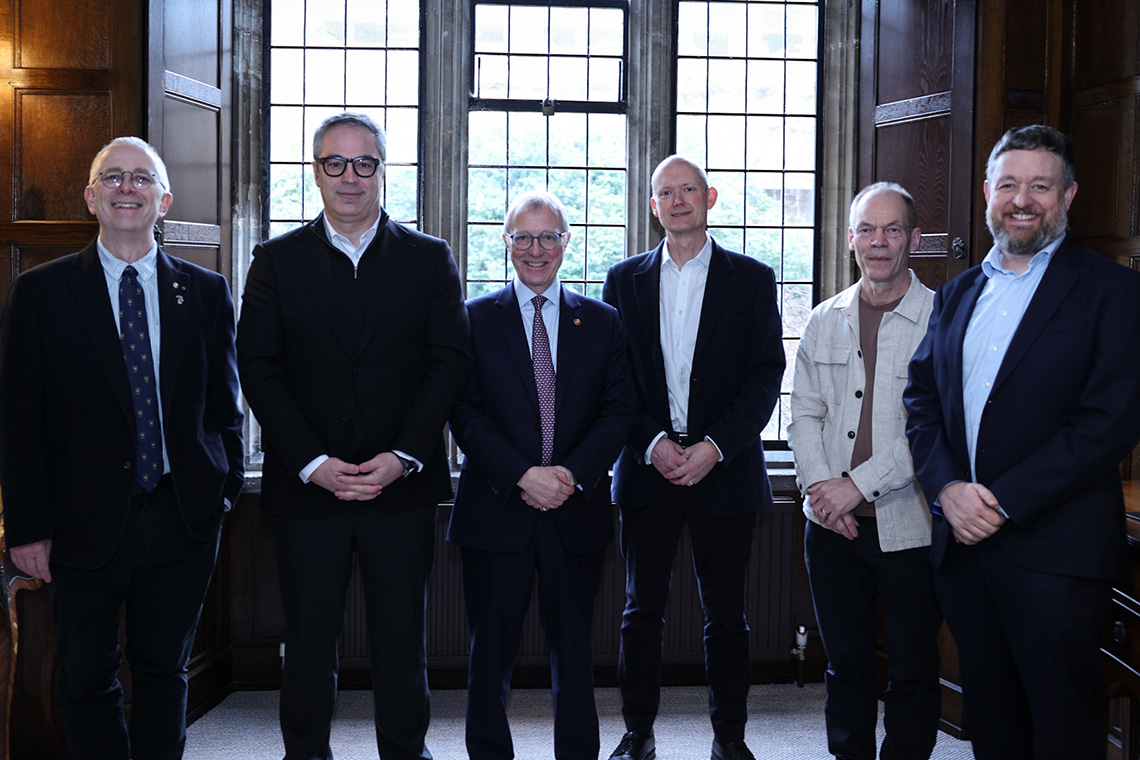 A group of men smiling towards the camera