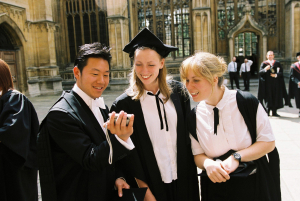 students looking happy, wearing gowns